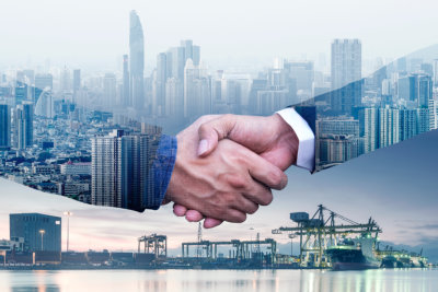 Businessmen are shaking hands to agree to a business deal success business of Logistics Industrial Container Cargo freight ship for Concept. The concept of modern life, business, city life internet.